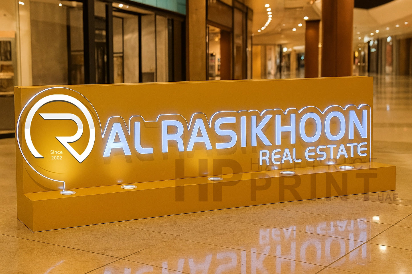 Al Rasikhoon Real Estate sign in a mall setting