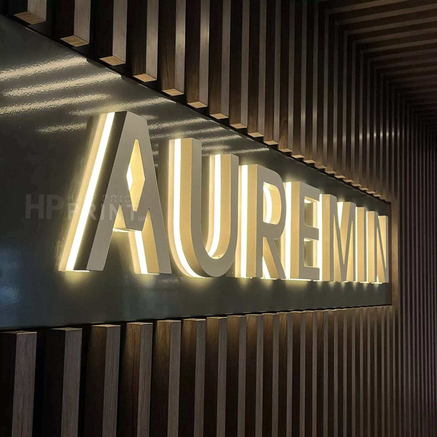 illuminated signage with 'AUREMIN' on a wooden slat background