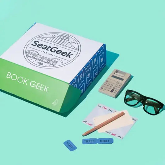 Custom printed book mailer box with stationery, sunglasses, calculator, and tickets on a blue background