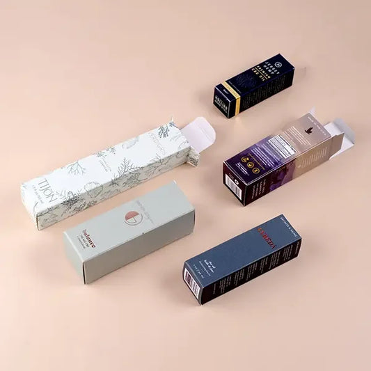 Custom printed tuck end packaging boxes for cosmetics and wellness products on beige background