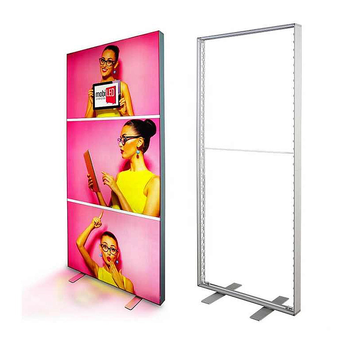 A trade show display stand featuring backlit panels with images of a woman in various poses, set next to its empty, non-backlit frame.