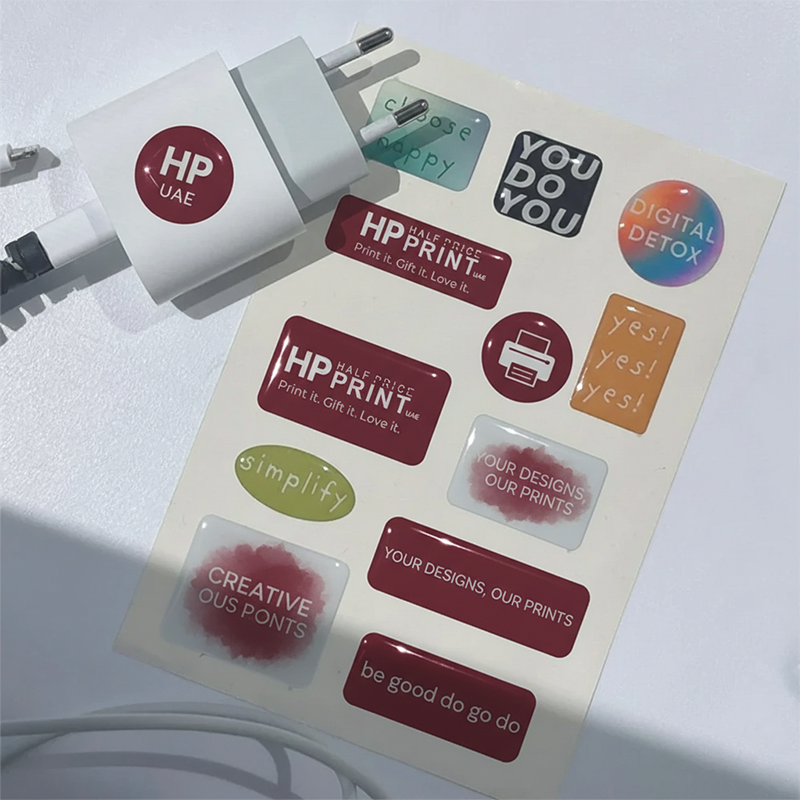 Sheet of Half Price Print epoxy stickers with various designs on a white background