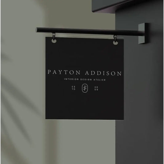 Black sign with 'Payton Addison' text on a gray background