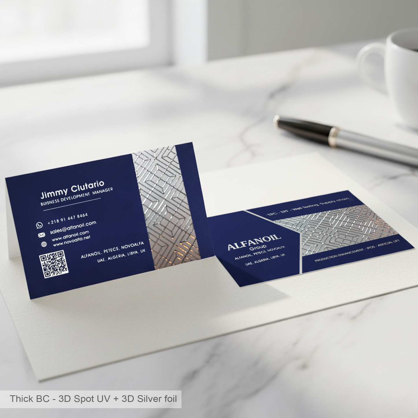 Navy blue thick business cards with silver foil and 3D effect on a white surface.