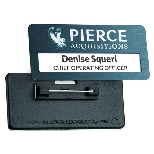 Rectangular name badge for Pierce Acquisitions with eagle logo, reading ‘Denise Squeri, Chief Operating Officer,’ shown with recycled plastic pin backing.