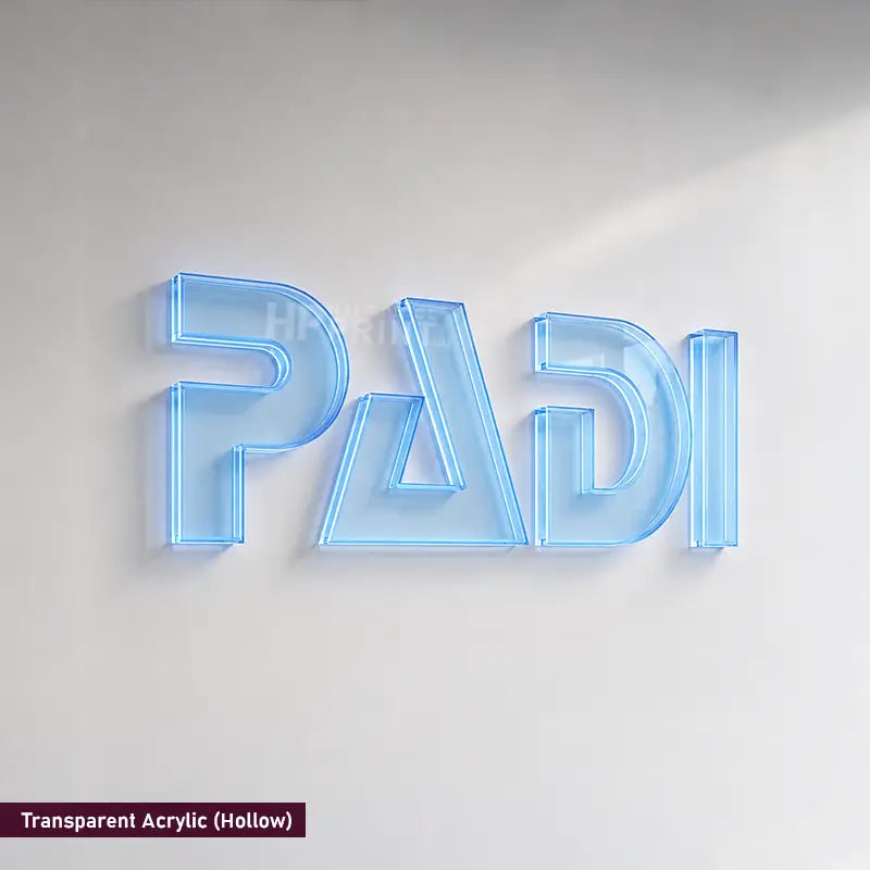 A 3D acrylic wall sign spelling 'PADI' in a transparent hollow style, glowing with a light blue neon-like effect against a plain light gray wall. A small label in the bottom-left corner reads 'Transparent Acrylic (Hollow)'.