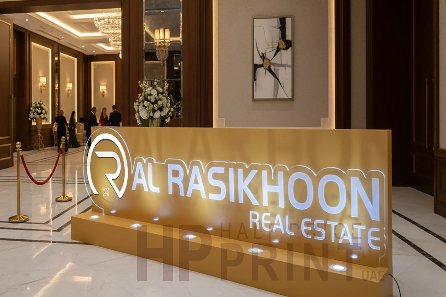 Al Rasikhoon Real Estate sign in a luxurious lobby setting