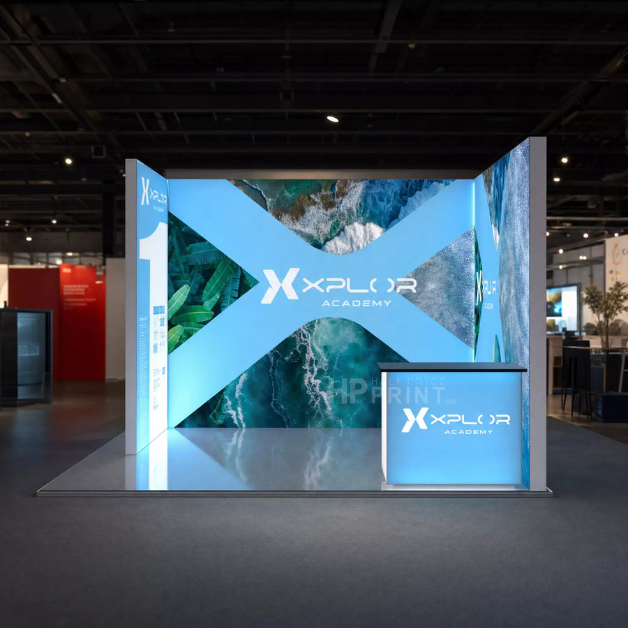 backlit display stand with Xplor Academy branding in a conference center setting