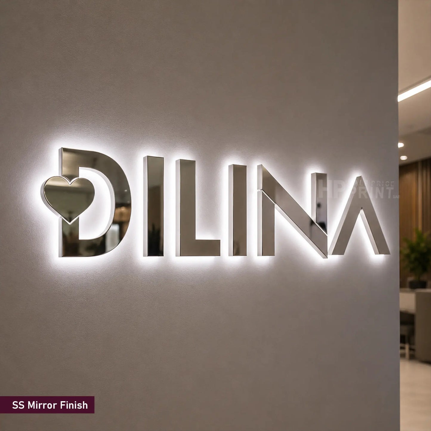 A large 3D LED backlit wall sign featuring the brand name 'DILINA' in a polished mirror-finish metallic material, with a heart cutout in the letter 'D'. A small label in the bottom-left corner reads 'SS Mirror Finish'.
