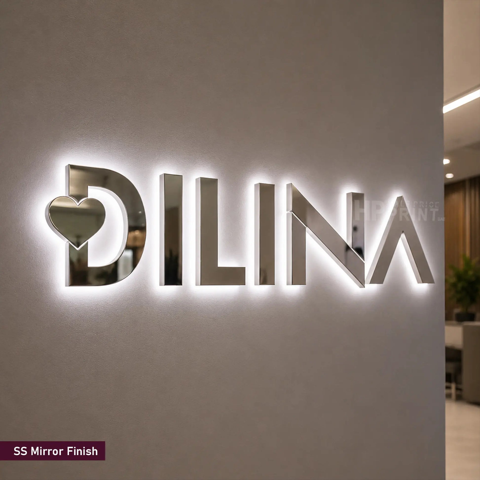 A large 3D LED backlit wall sign featuring the brand name 'DILINA' in a polished mirror-finish metallic material, with a heart cutout in the letter 'D'. A small label in the bottom-left corner reads 'SS Mirror Finish'.