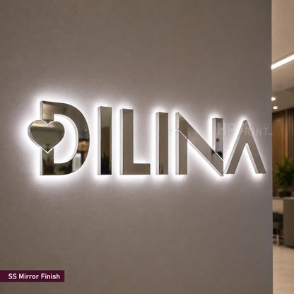 A large 3D LED backlit wall sign featuring the brand name 'DILINA' in a polished mirror-finish metallic material, with a heart cutout in the letter 'D'. A small label in the bottom-left corner reads 'SS Mirror Finish'.