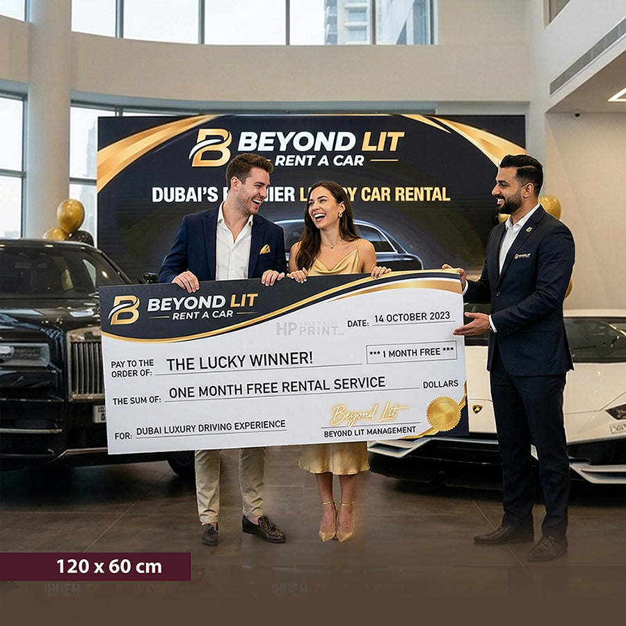 Two men and a woman holding a large cheque in front of a Beyond Lit Rent a Car backdrop.
