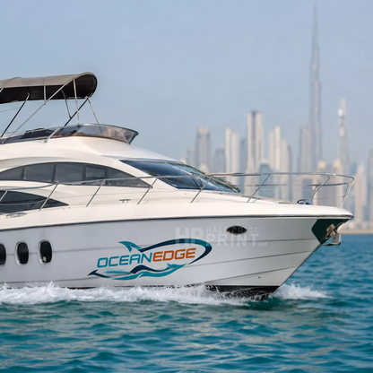 A white Ocean Edge motor yacht along with sticker sailing on blue water with a blurred city skyline in the background, featuring the Burj Khalifa.