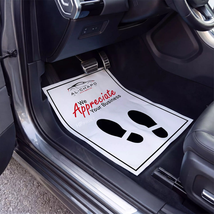 Car interior with a mat displaying 'We Appreciate Your Business' text and logo.