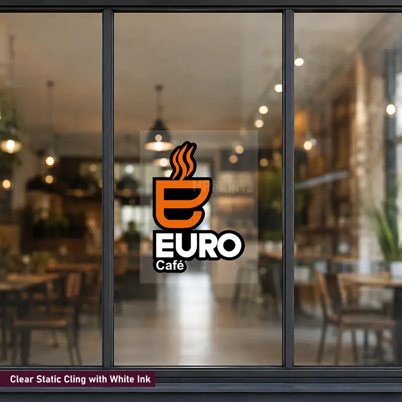 A clear static cling sticker with white text reading 'EURO Café' and an orange coffee cup icon, applied to a large window in a blurred cafe interior. A small label at the bottom reads 'Clear Static Cling with White Ink'.