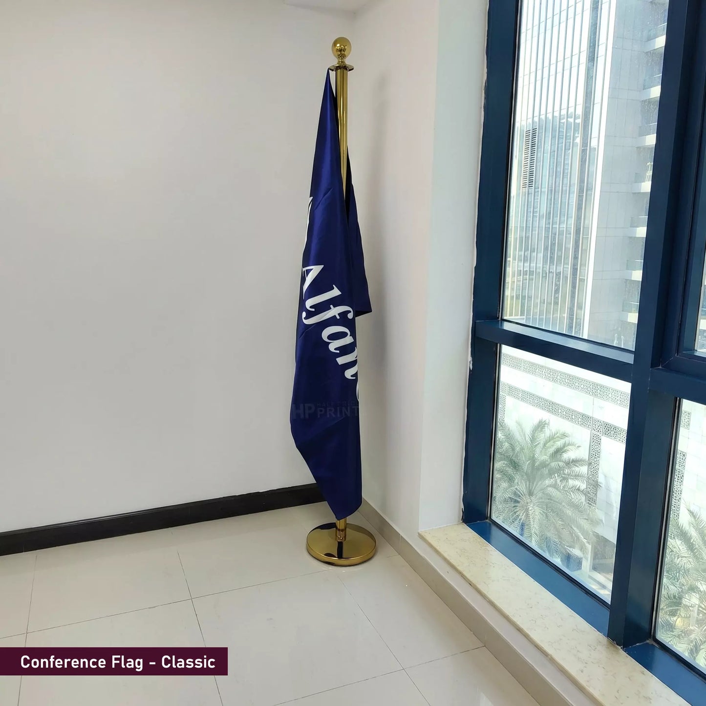 Blue conference flag with gold pole against a windowed wall.