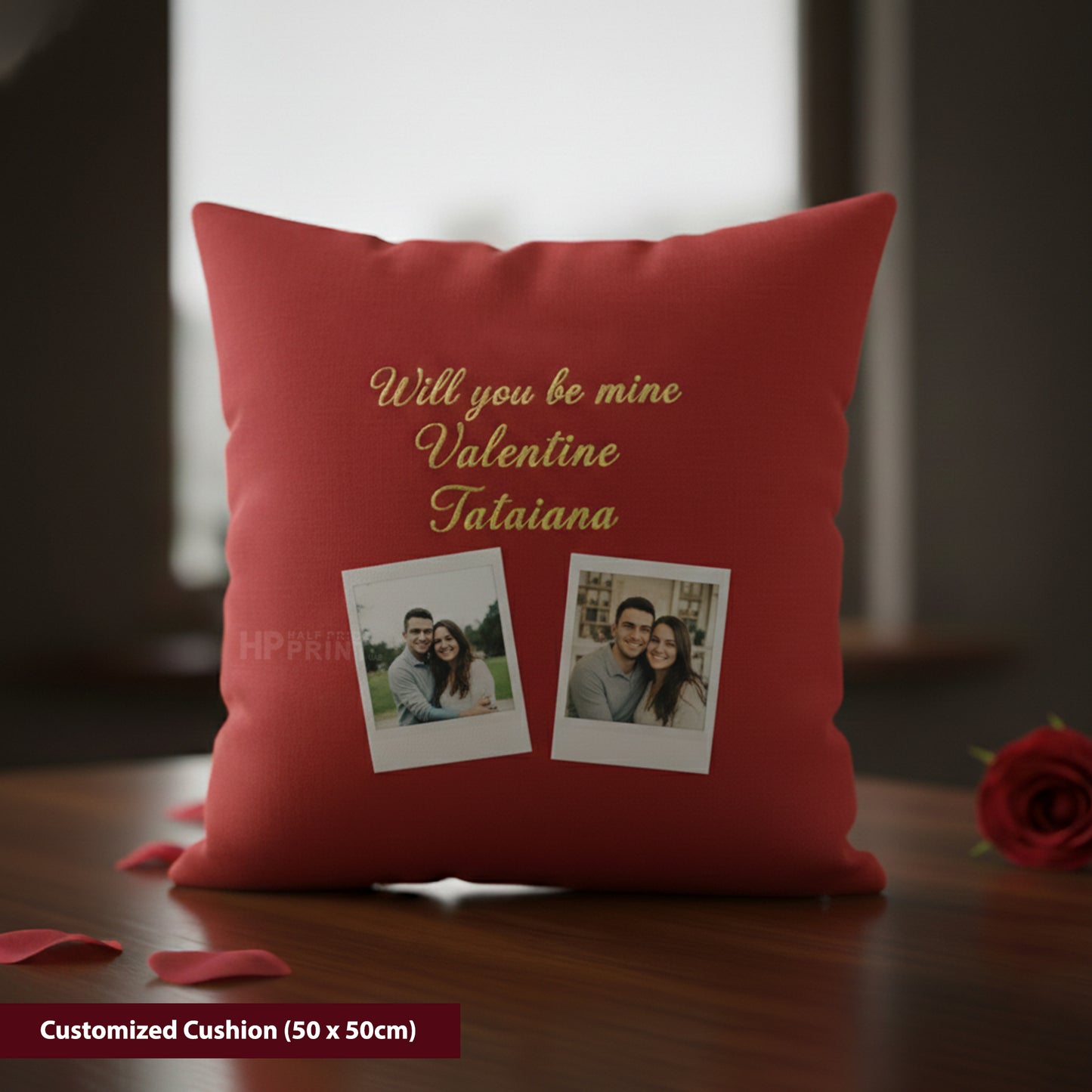 Red cushion with personalized text and photos on a wooden surface