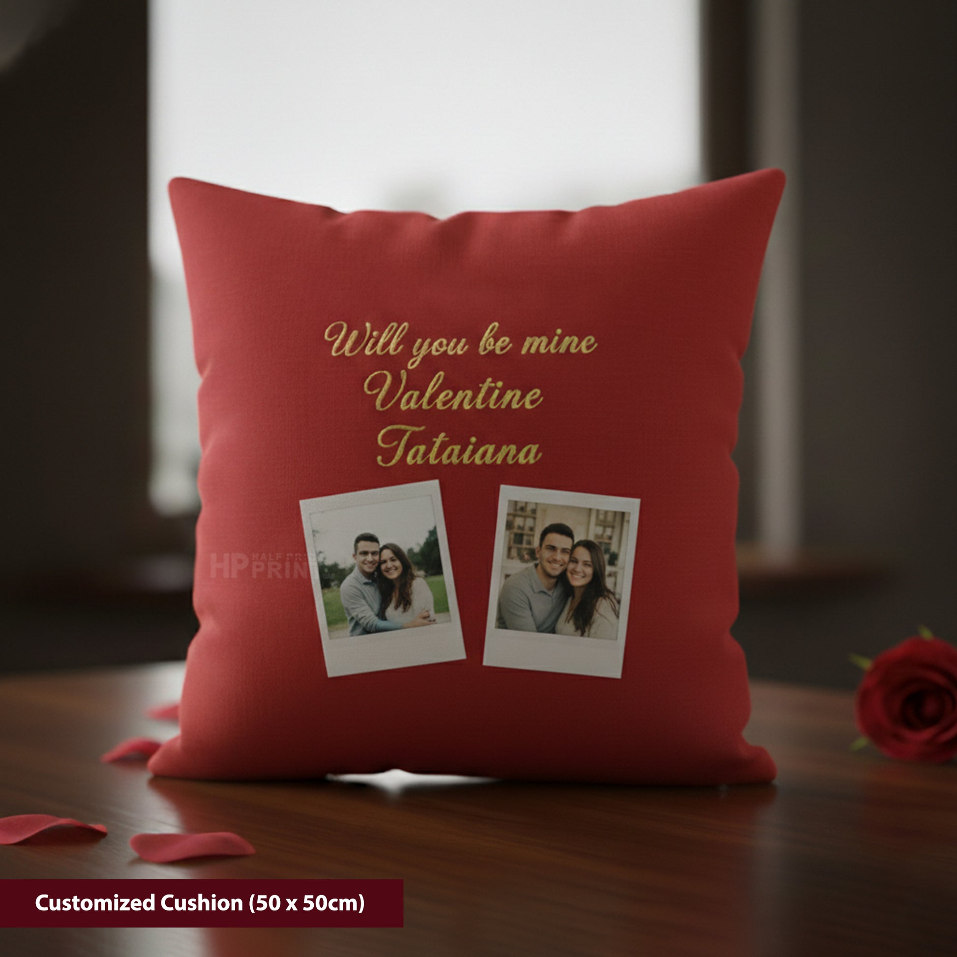 Red cushion with personalized text and photos on a wooden surface