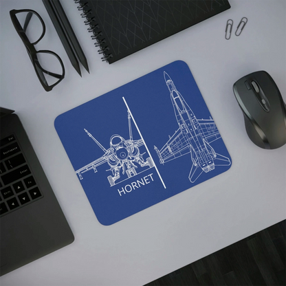 Blue mouse pad with airplane design and 'Hornet' text on a desk with laptop, mouse, and glasses.