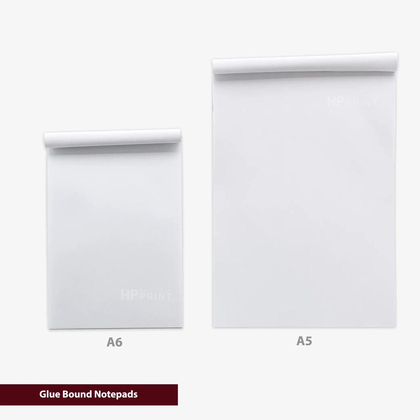 Two white notepads labeled A6 and A5 on a white background with 'Glue Bound Notepads' text.