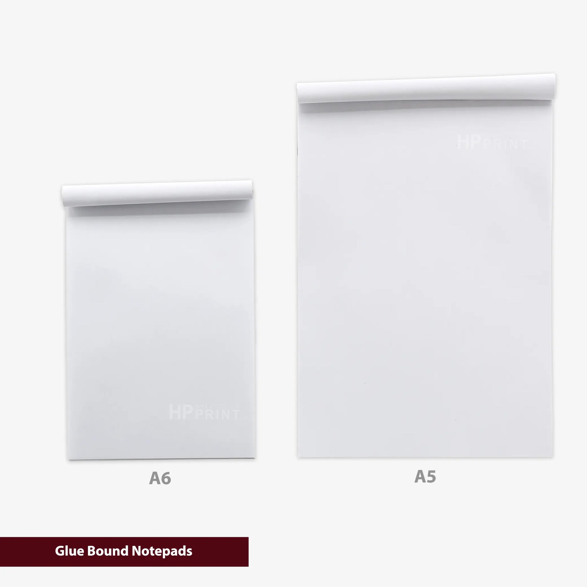 Two white notepads labeled A6 and A5 on a white background with 'Glue Bound Notepads' text.