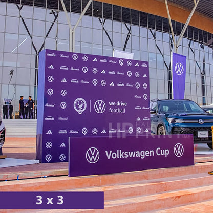 Volkswagen Cup event setup with branded backdrop and car in the background