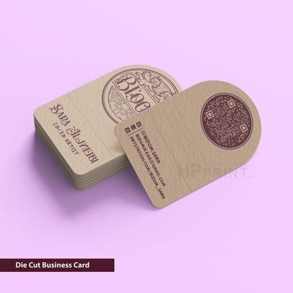 Die cut business cards with a decorative design on a purple background