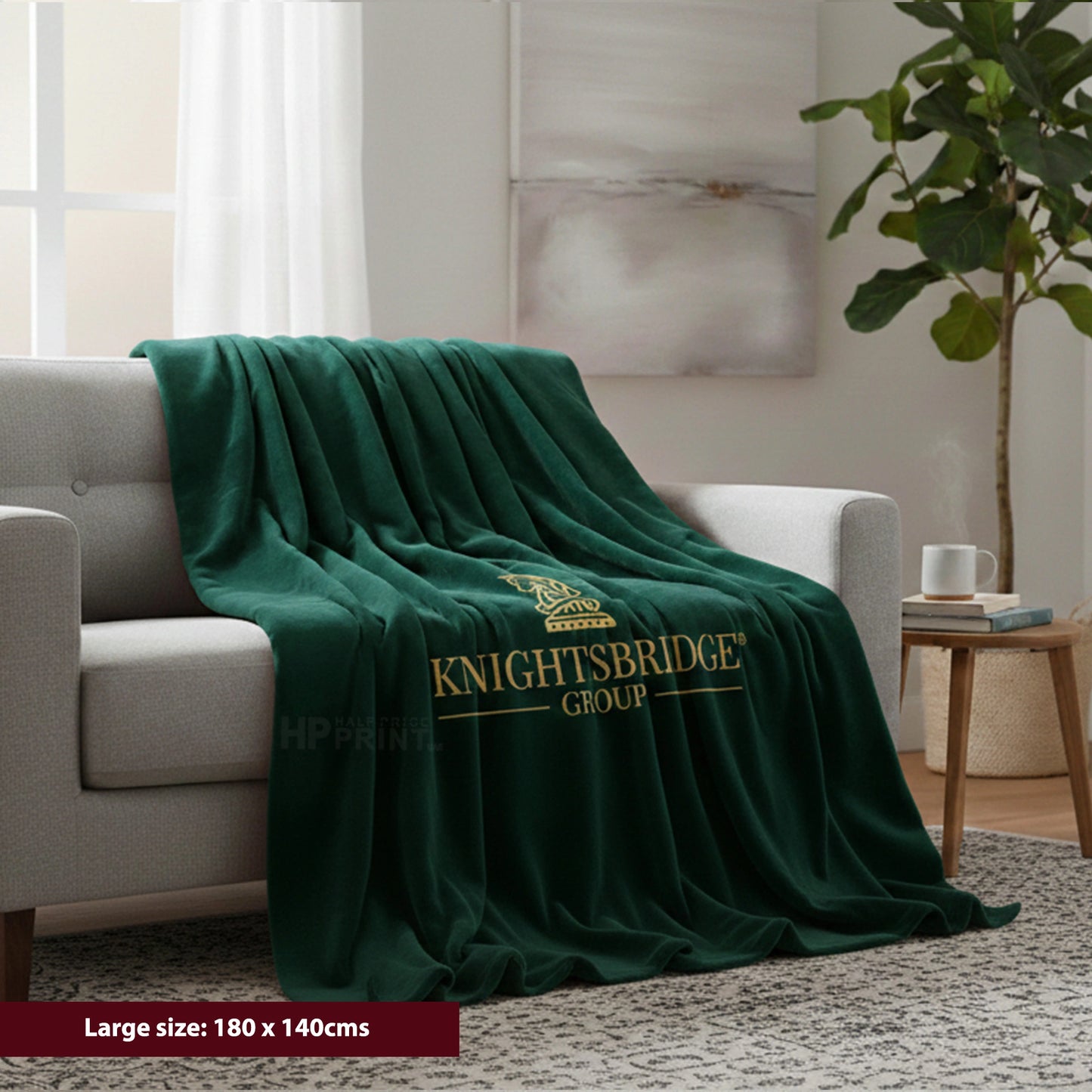 Green blanket with 'Knightsbridge Group' logo draped over a sofa in a living room.