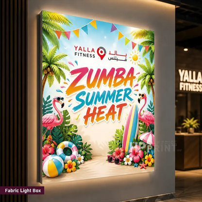 A colorful fabric light box poster print featuring a tropical summer theme with flamingos, palm trees, a surfboard, and the text 'ZUMBA SUMMER HEAT' and 'YALLA FITNESS'. The light box is mounted on a wall in a fitness center environment.