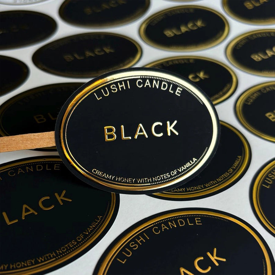 Black round foil stickers with gold text and border, displaying the word 'BLACK' and the brand 'LUSHI CANDLE'.