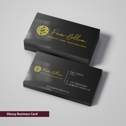 Black business cards with gold text and logo on a gray background