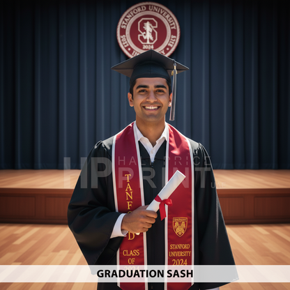 A boy graduate in a cap and gown, wearing a sash, proudly holding a diploma with the Stanford University logo in the background.