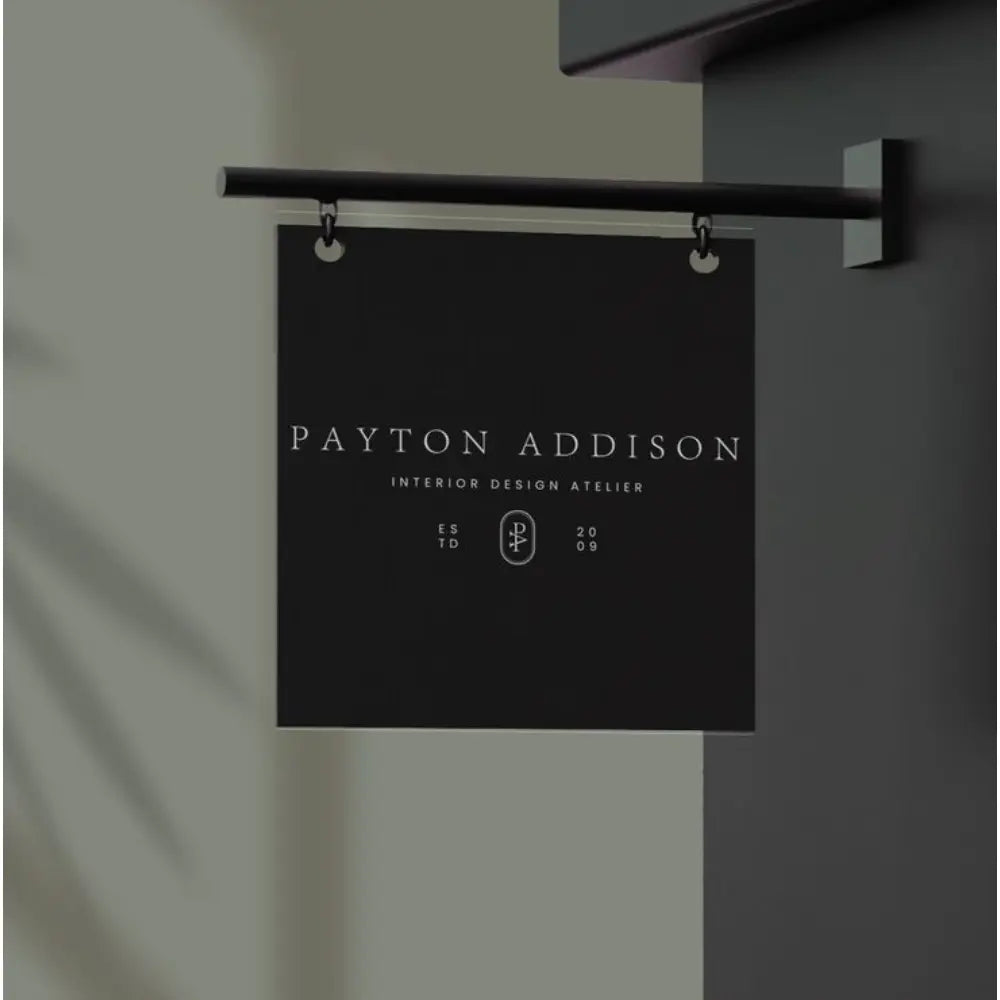 Black sign with 'Payton Addison' text on a gray background