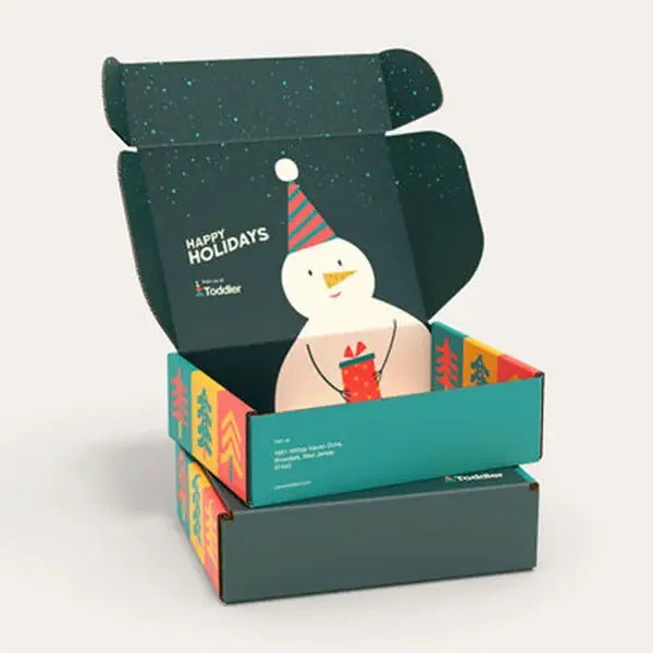 Holiday mailer box with festive snowman design, colorful trees, and gift packaging
