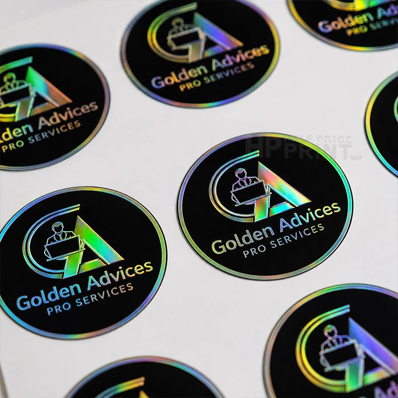 Several round holographic stickers on a white background, each featuring a black circle with the text 'Golden Advises PRO SERVICES' and a stylized golden 'A' logo.