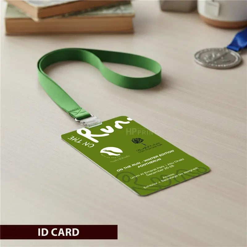 Green ID card with lanyard on a wooden surface