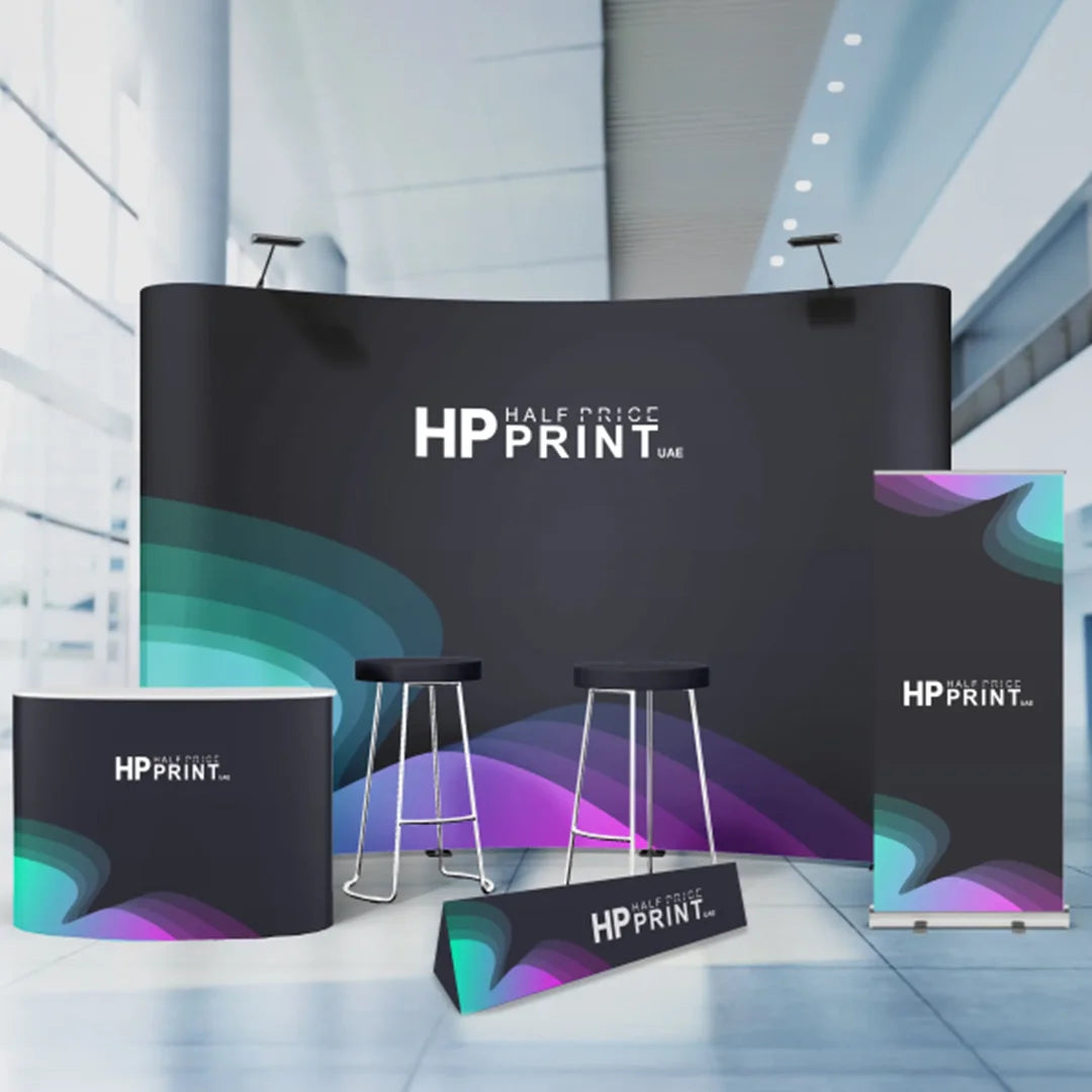 HP Print display setup with banners, table, and stools in a modern indoor setting.