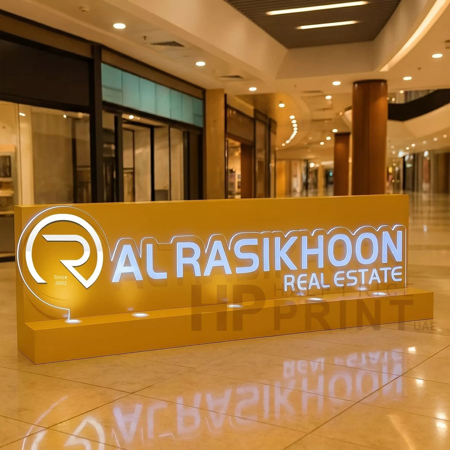 Al Rasikhoon Real Estate sign in a shopping mall setting
