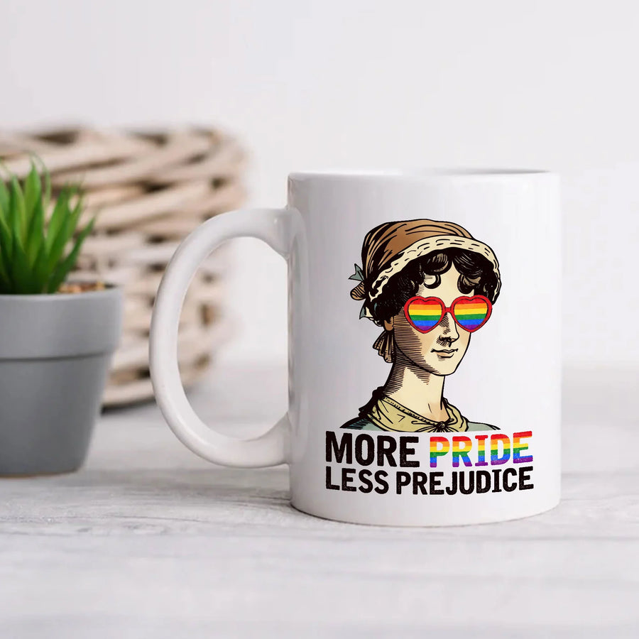 Custom printed mug featuring a woman in rainbow heart sunglasses and 'More Pride Less Prejudice' text, on a light table next to a small plant.
