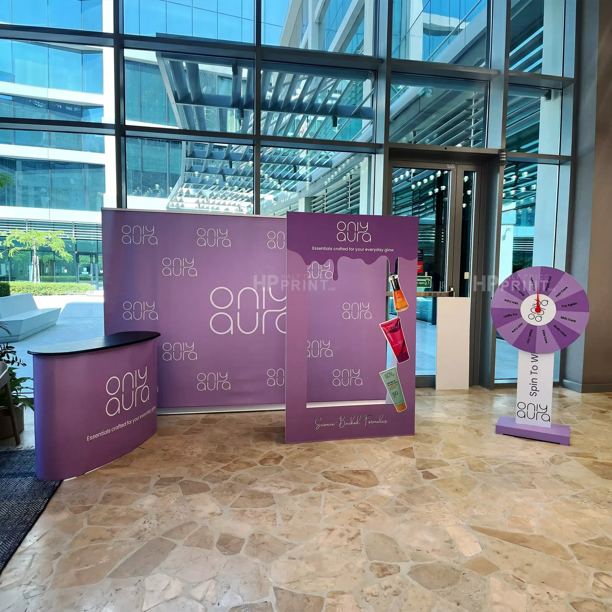 Promotional setup with purple 'only aura' branding in a modern indoor setting.