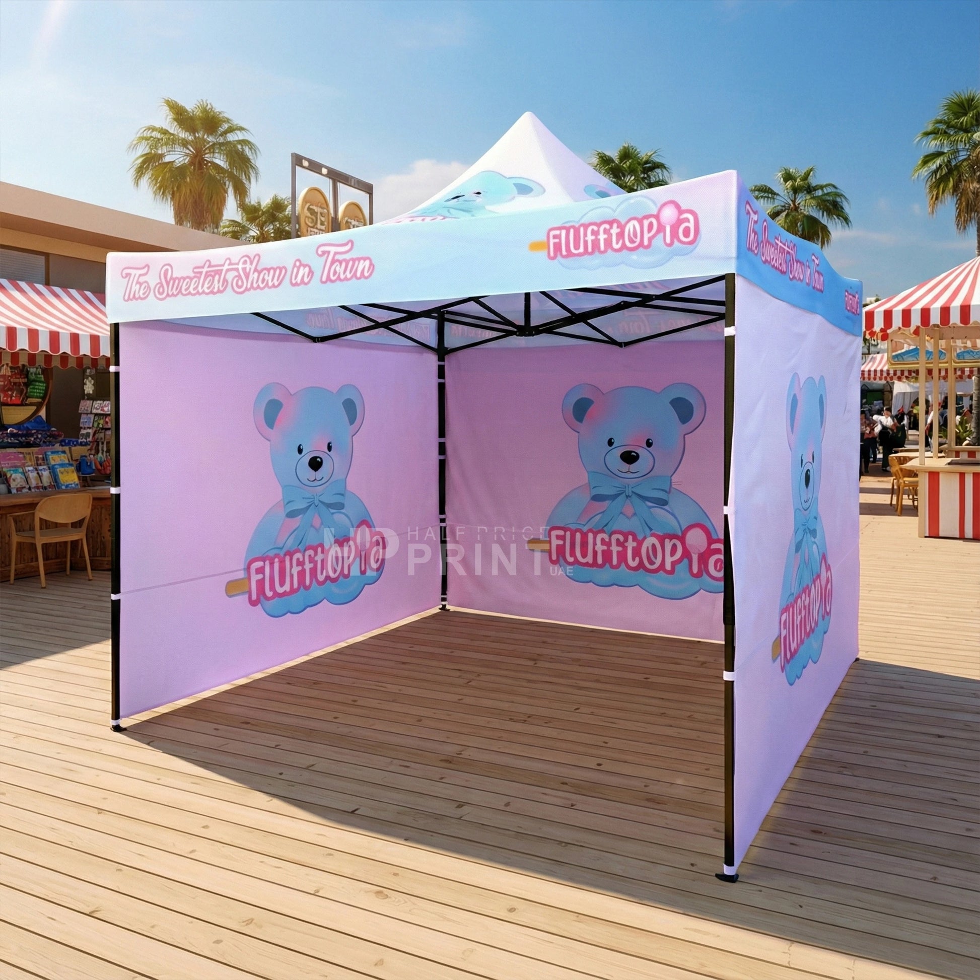 Outdoor event tent with 'Flufftopia' branding and teddy bear graphics on a wooden deck.