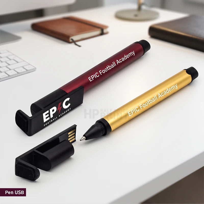 Two EPIC Football Academy USB pen drives on a white desk, one in metallic gold and one in metallic burgundy, each with a black USB connector, alongside a black EPIC stand.