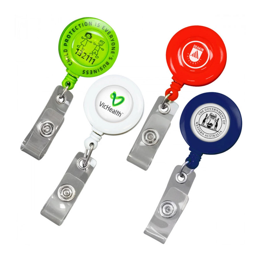 A collection of reel badges with epoxy coating in various colors, attached to retractable clips and ID card holders, with custom graphics and branding printed on them.