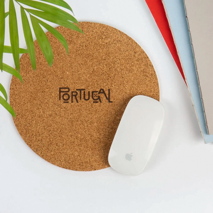 Round mouse pad with a plant and books in the background.