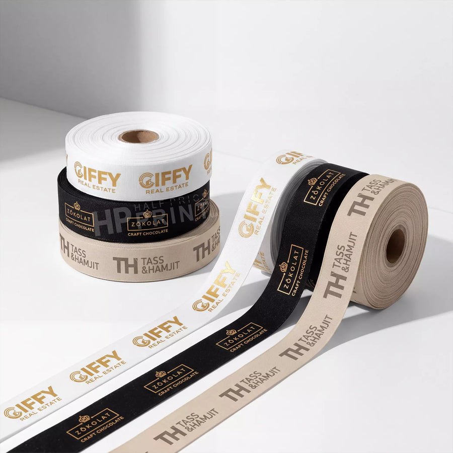 Ribbon Rolls of paper with printed branding on a light background