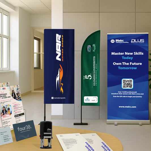 Promotional materials including banners and brochures on a table in an office setting.