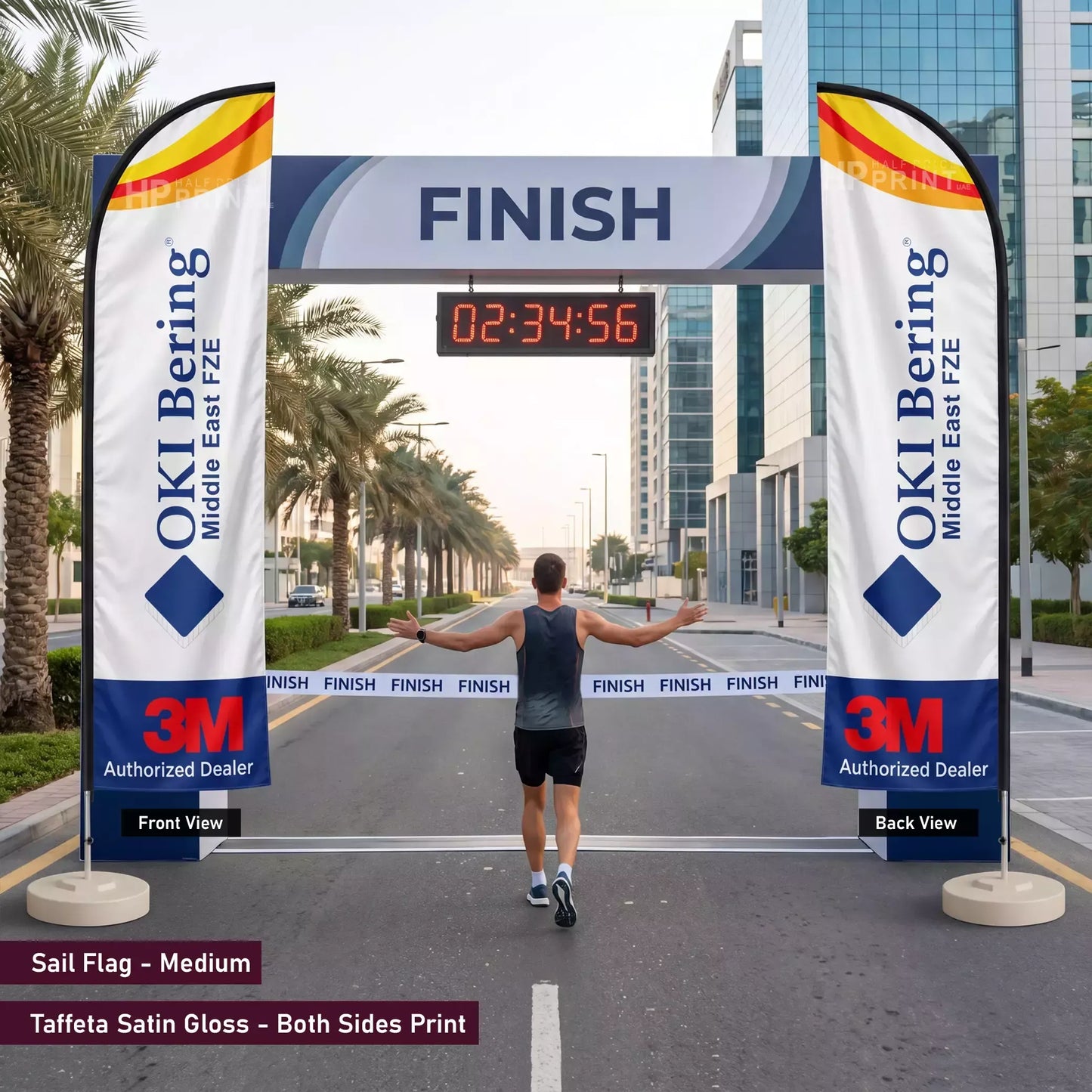 Man crossing a finish line with OKI Bering and 3M branding on sail flags.