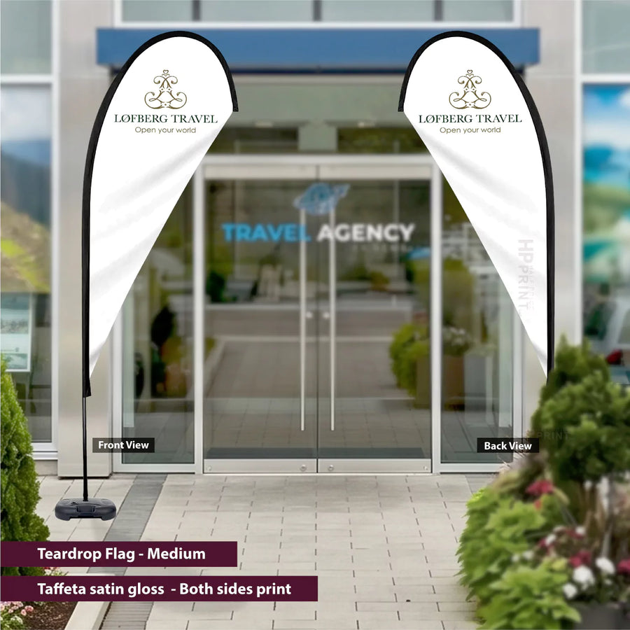 Tear drop flags with Lofberg Travel branding in front of a travel agency entrance.