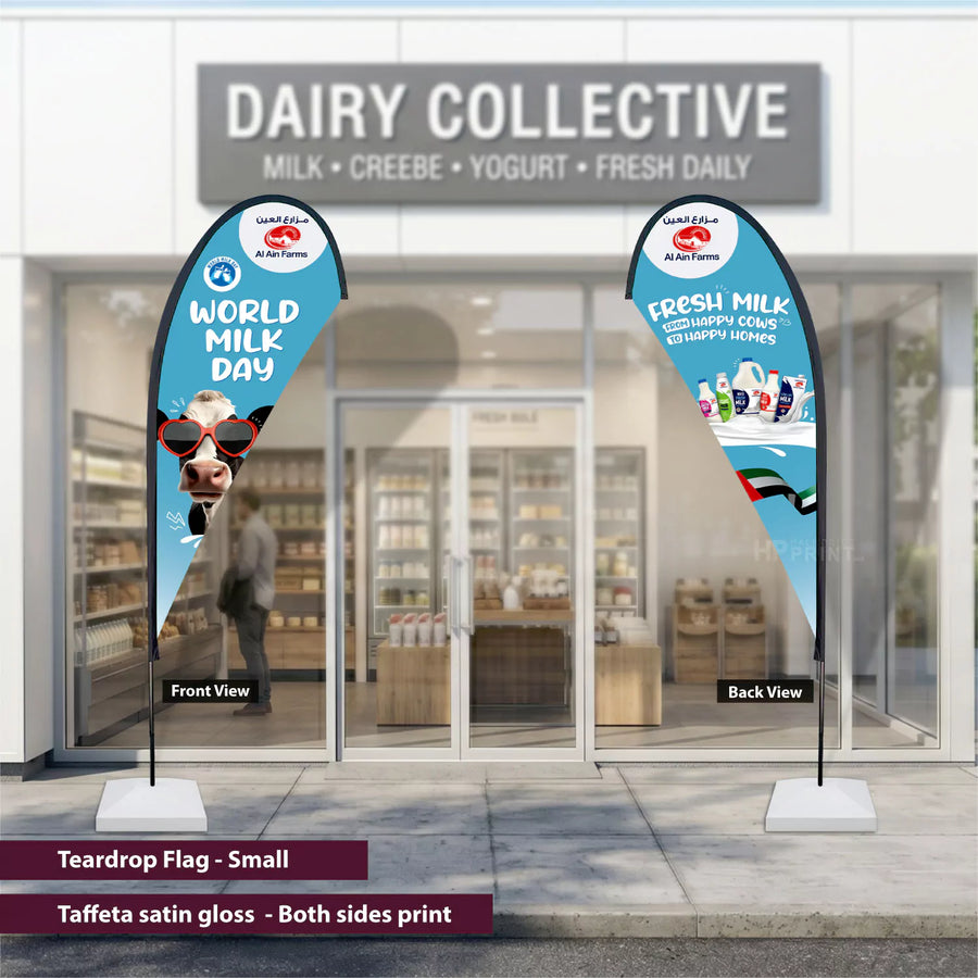 Teardrop flags for World Milk Day in front of a store named 'Dairy Collective'.