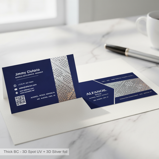 Navy blue thick business cards with silver foil and 3D effect on a white surface.